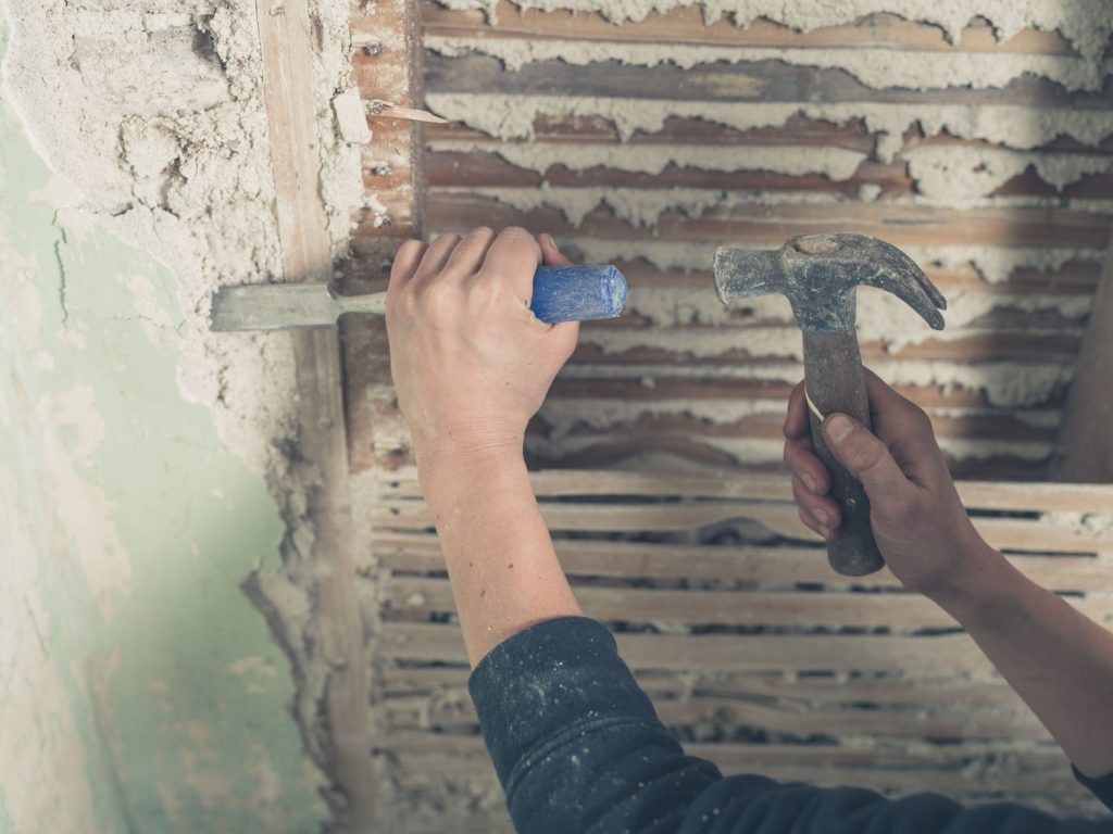 removing asbestos with hammer